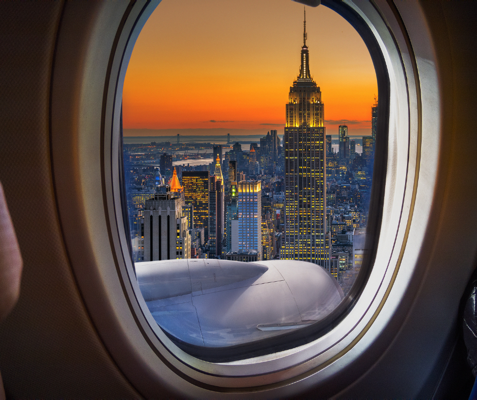 in flight window seat, city outside